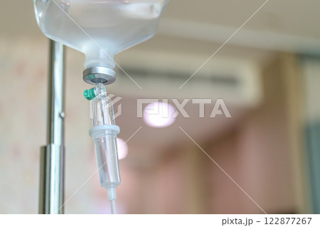 Close up medical intravenous IV drip in hospital background Close up medical intravenous IV drip in hospital background 122877267