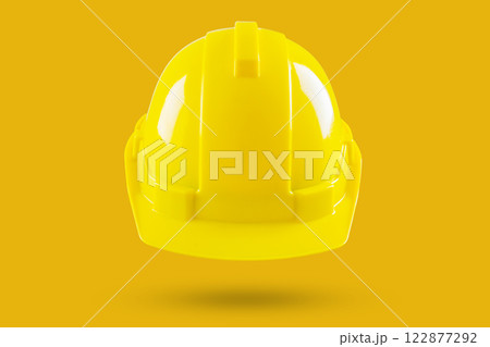 Safety construction helmet on yellow background 122877292