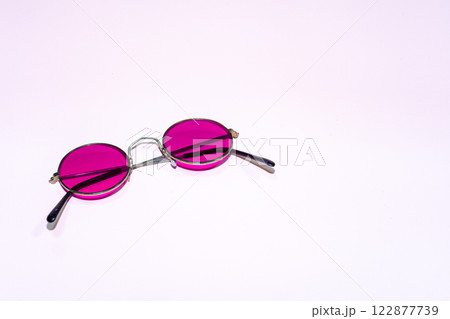 Purple round sunglasses on a pink background 122877739