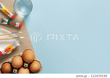 Preparation for Easter celebration. Painting Easter eggs with acrylic pigment dyes in tubes. Clean brown eggshells. Preparation for Easter celebration. Painting Easter eggs with acrylic pigment dyes in tubes. Clean brown eggshells. 122879190