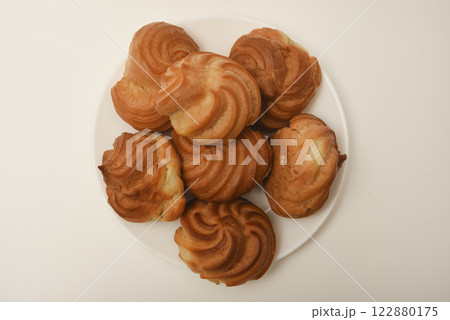 A custard pie. Eclair with cream. Delicious profiteroles. 122880175
