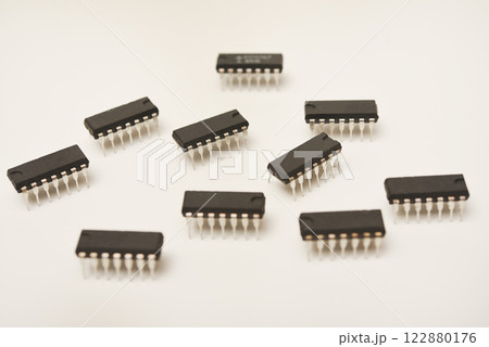 A microcontroller on a white background. An electronic chip in a plastic case. 122880176