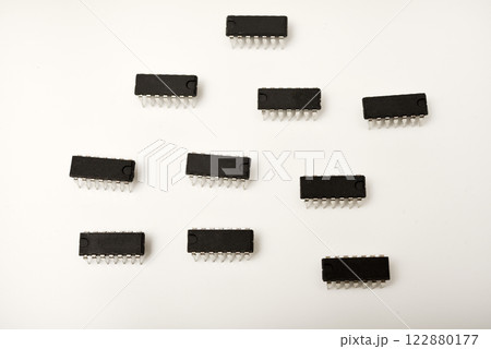 A microcontroller on a white background. An electronic chip in a plastic case. A microcontroller on a white background. An electronic chip in a plastic case. 122880177