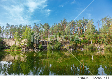 beautiful lake with a canyon on which swans swim with a blue sky beautiful lake with a canyon on which swans swim with a blue sky 122880311