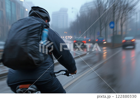 Cyclist on the road in the city. Blurred background 122880330