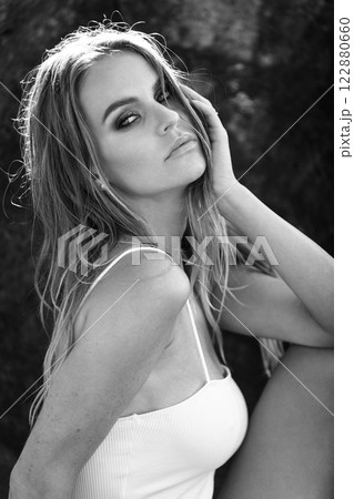 Serene Black and White Portrait of a Woman in a White Top with Sunlit Hair in Nature Serene Black and White Portrait of a Woman in a White Top with Sunlit Hair in Nature 122880660