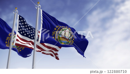 New Hampshire and National US flags waving in the wind on a clear day New Hampshire and National US flags waving in the wind on a clear day 122880710