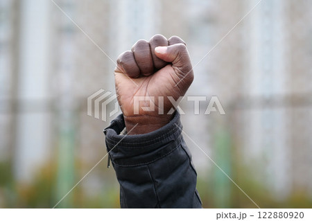 Raised black man fist in protest 122880920