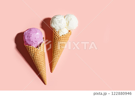 Two crispy ice cream cones vanilla and blueberry flavors Two crispy ice cream cones vanilla and blueberry flavors 122880946