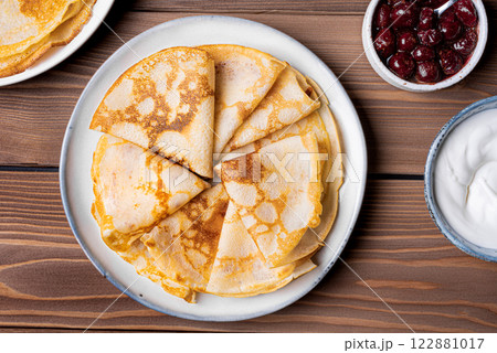 Homemade crepes pancakes with sour cream and cherry syrup Homemade crepes pancakes with sour cream and cherry syrup 122881017