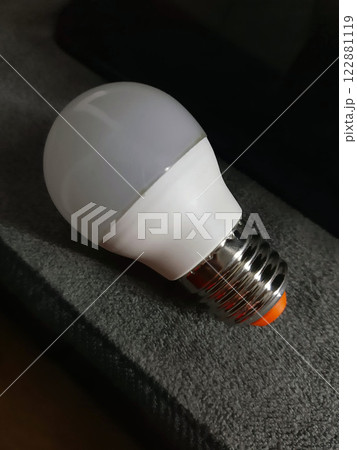 Light bulb on a gray background close-up Light bulb on a gray background close-up 122881119