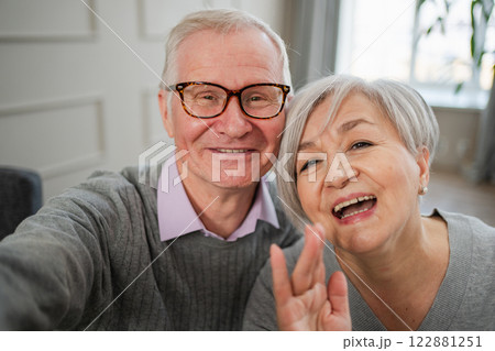 Happy senior woman man talk on video call with friends family. Mature old grandmother grandfather talking speaking with grown up children online. Older generation modern tech usage. Webcamera view 122881251
