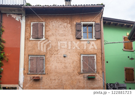 Colorfull houses in a street of the Malcesine, town on the shore of Lake Garda, Italy, Europe. Colorfull houses in a street of the Malcesine, town on the shore of Lake Garda, Italy, Europe. 122881723