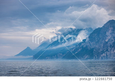 Lake Garda with mountains in background, view from Malcesine town on the eastern shore of the lake, Italy, Europe. 122881750