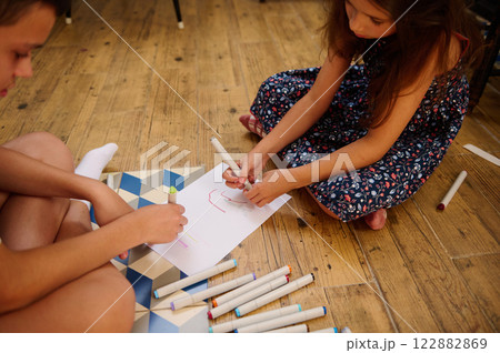 Children Drawing Together on Paper 122882869