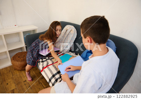 Children Discussing Schoolwork at Home 122882925