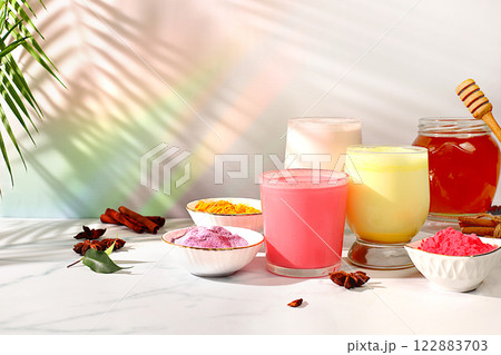 An assortment of colorful matcha lattes, Japanese tea, golden turmeric, lavender blue and pink moon milk. The trendy healthy drink promotes weight loss, a relaxing drink before bed and has An assortment of colorful matcha lattes, Japanese tea, golden turmeric, lavender blue and pink moon milk. The trendy healthy drink promotes weight loss, a relaxing drink before bed and has 122883703