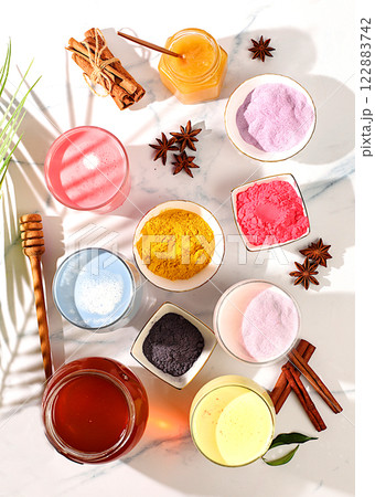 An assortment of colorful matcha lattes, Japanese tea, golden turmeric, lavender blue and pink moon milk. The trendy healthy drink promotes weight loss, a relaxing drink before bed and has 122883742