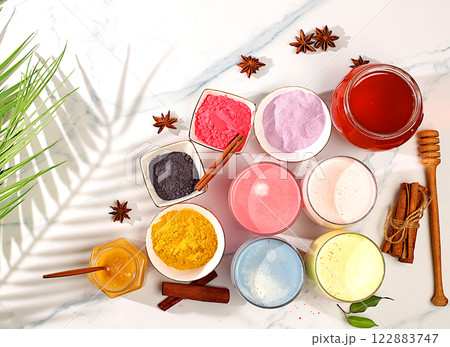 An assortment of colorful matcha lattes, Japanese tea, golden turmeric, lavender blue and pink moon milk. The trendy healthy drink promotes weight loss, a relaxing drink before bed and has An assortment of colorful matcha lattes, Japanese tea, golden turmeric, lavender blue and pink moon milk. The trendy healthy drink promotes weight loss, a relaxing drink before bed and has 122883747