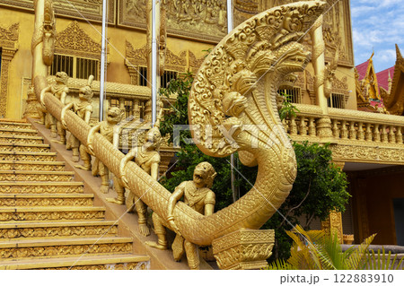Many asura demon statues holding Naga snake statue, Wat Kean Kleang golden temple, Phnom Penh, Cambodia Many asura demon statues holding Naga snake statue, Wat Kean Kleang golden temple, Phnom Penh, Cambodia 122883910