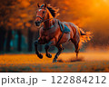 A powerful horse runs swiftly across an open field, surrounded by autumn foliage. The vibrant colors and sharp details capture the speed and grace of the animal in motion. 122884212