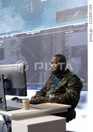 Specialist handles intelligence gathering activity with classified information and satellite systems, data processing and strategic planning. Military man ensures national interests protection. 122885104