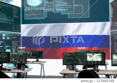 Governmental cyber operations room with Russian flag on big screen, focusing on information war and trolling. Highlighting the role of hackers in spreading disinformation and crowd control. Governmental cyber operations room with Russian flag on big screen, focusing on information war and trolling. Highlighting the role of hackers in spreading disinformation and crowd control. 122885109