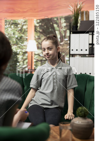 Adolescent struggles with personal issues during a therapy session discussing about her intrusive thoughts with psychotherapist. Expert supports her through depression and anxiety. 122885150