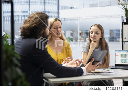 Advisor working with clients to create long term investment strategies, doing retirement planning. Consultant helps family set realistic financial goals and develop roadmap to achieve them 122885214