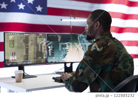 Dedicated military team operates high tech systems in a command post, focusing on surveillance and data protection to ensure national security and effective defense strategies. 122885232