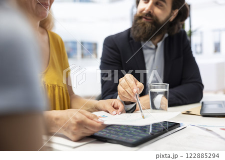 Financial advisor in office with mother and gen Z girl to provide personalized spending plan. Agent evaluating clients financial needs, performing analysis during business meeting Financial advisor in office with mother and gen Z girl to provide personalized spending plan. Agent evaluating clients financial needs, performing analysis during business meeting 122885294