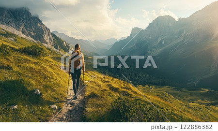 A man is walking on a trail in the mountains 122886382