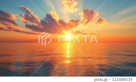 The sun is setting over the ocean, casting a warm glow on the water 122886535