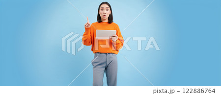 Eureka, got an idea. Excited asian woman with digital tablet, raising finger up, got revelation, has great solution, stands over blue background Eureka, got an idea. Excited asian woman with digital tablet, raising finger up, got revelation, has great solution, stands over blue background 122886764