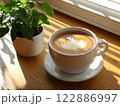 Morning coffee with latte art on a wooden table next to a potted plant. Perfect for promoting a cafe or creating a relaxing atmosphere on social media. It gives a feeling of warmth start to the day. 122886997