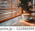Morning coffee with latte art on a wooden table next to a potted plant. Perfect for promoting a cafe or creating a relaxing atmosphere on social media. It gives a feeling of warmth start to the day. 122886998