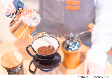 ドリップケトルでコーヒーを淹れる若い女性店員 顔無し ドリップケトルでコーヒーを淹れる若い女性店員 顔無し 122887658