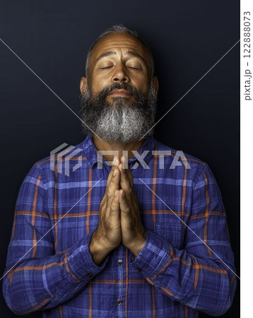 Grateful Latino Man with Clapping Hands and Blissful Expression Grateful Latino Man with Clapping Hands and Blissful Expression 122888073