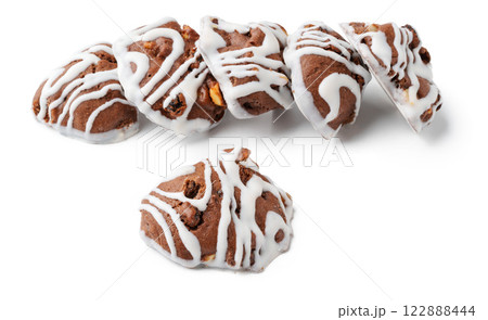 Chocolate cookies with icing arranged artfully on a surface ready for dessert lovers to enjoy Chocolate cookies with icing arranged artfully on a surface ready for dessert lovers to enjoy 122888444