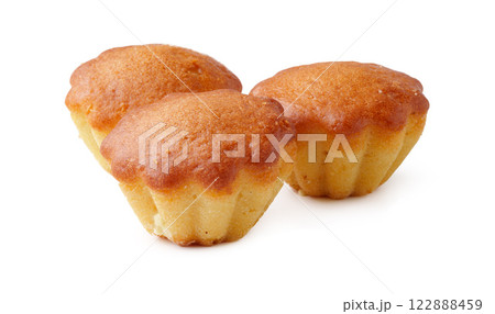 Bakery treats on a white background highlighting three golden mini cakes with a smooth texture Bakery treats on a white background highlighting three golden mini cakes with a smooth texture 122888459