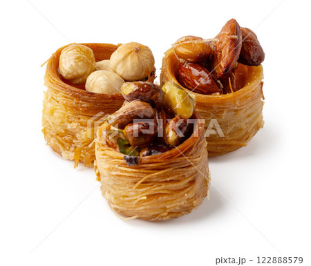 Delicious dessert featuring a variety of nuts wrapped in sweet pastry, perfect for festive occasions or indulgent treats Delicious dessert featuring a variety of nuts wrapped in sweet pastry, perfect for festive occasions or indulgent treats 122888579