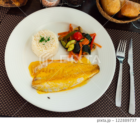 Sea bass with curry, vegetables and rice Sea bass with curry, vegetables and rice 122889737