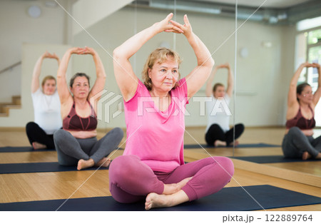 People studying new position at yoga school 122889764