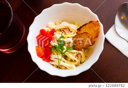 Salad of cabbage, eggs, sausages and mayonnaise with toasted baguette 122889782