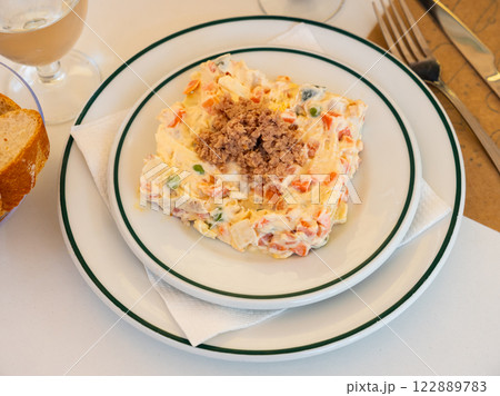 Popular salad of Spanish cuisine called Ensalada rusa 122889783