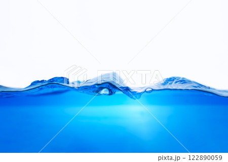 Closeup view of dynamic flowing blue water waves on white background. Liquid splash. Texture and abstract background Closeup view of dynamic flowing blue water waves on white background. Liquid splash. Texture and abstract background 122890059