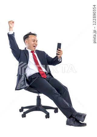 Portrait of an Asian businessman holding his mobile phone with an excited expression isolated over a white background. Concept of Indonesian business and technology 122890354