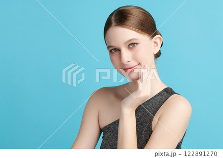 Beautiful young woman with clean fresh skin on blue background, Face care, Facial treatment, Cosmetology, beauty and spa, women portrait. 122891270