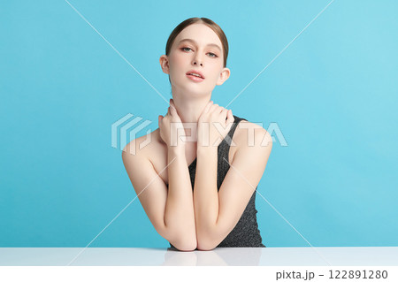 Beautiful young woman with clean fresh skin on blue background, Face care, Facial treatment, Cosmetology, beauty and spa, women portrait. 122891280