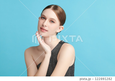 Beautiful young woman with clean fresh skin on blue background, Face care, Facial treatment, Cosmetology, beauty and spa, women portrait. 122891282